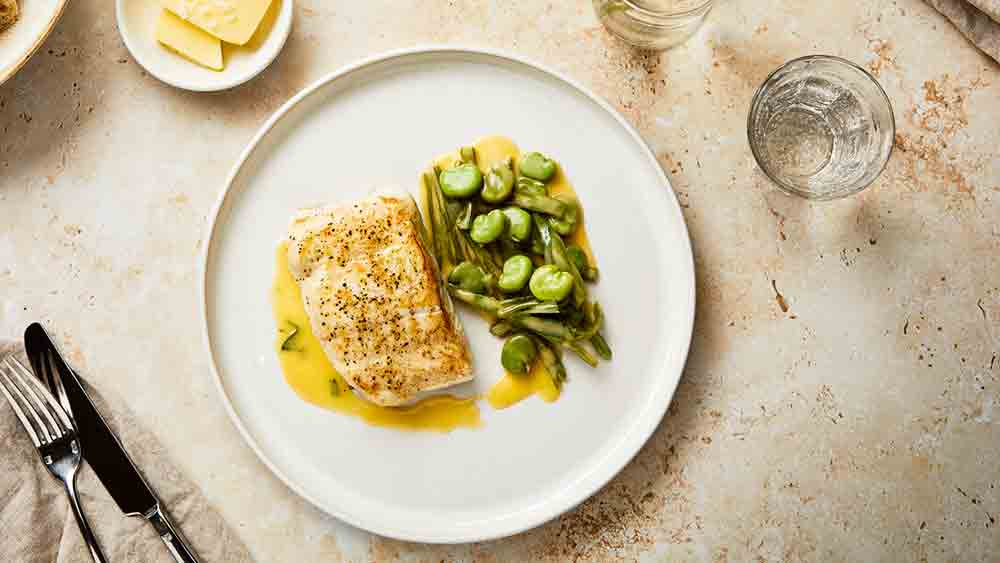 pan fried halibut with beurre blanc on plate